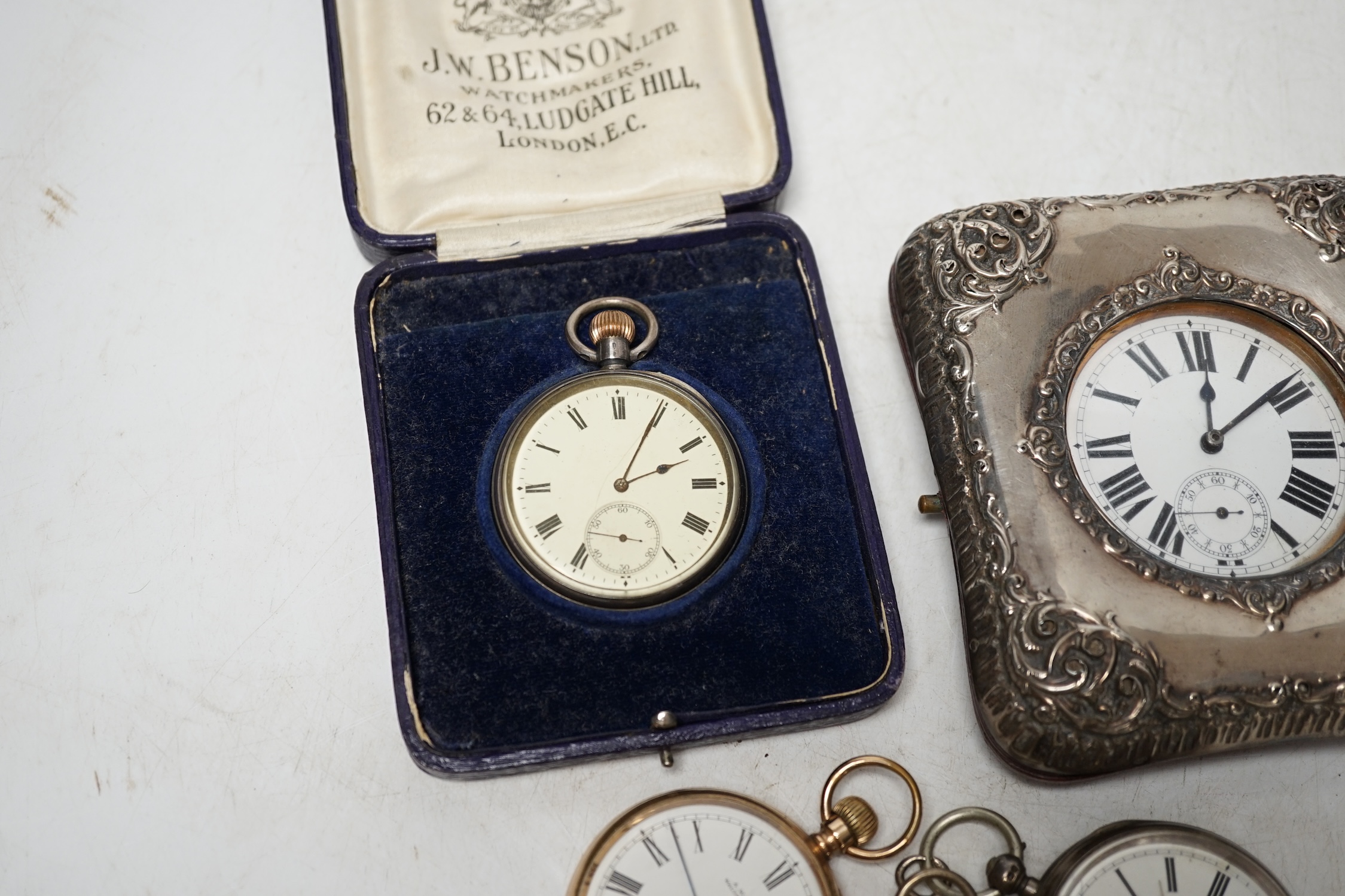 A George V repousse silver mounted travelling watch case (a.f.), with pocket watch, three silver open face pocket watches and a Waltham gold plated pocket watch. Condition - poor to fair